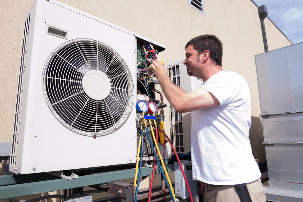 HVAC technician working on a mini-split condensing unit