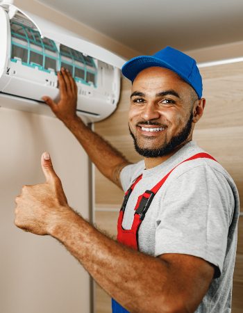 professional-repairman-installing-air-conditioner-HLXERZ5-1.jpg